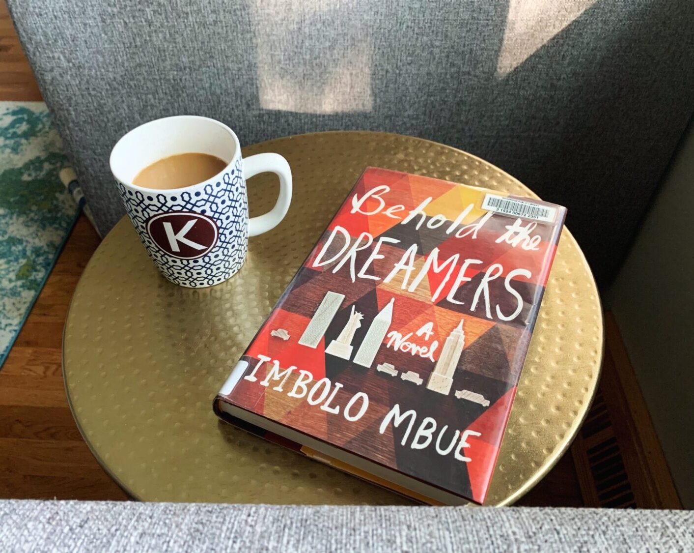 Coffee cup and Behold the Dreamers book in the sunshine. Part of my Sunday routine for success.