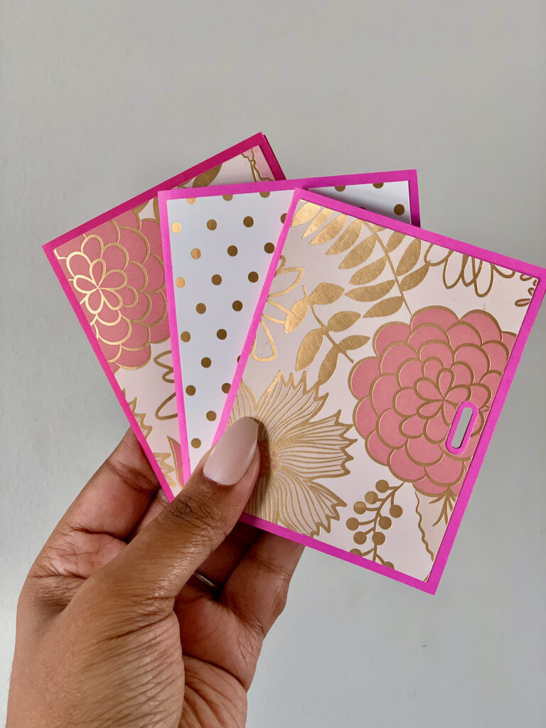 Three teachers gift card holders made with Cricut machine. Pink and gold flower designs on the front of the cards.