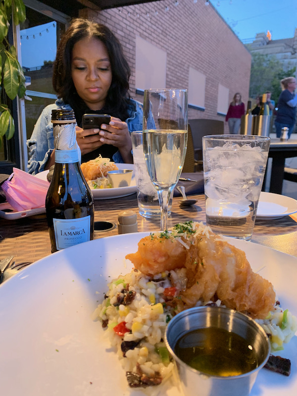 Dinner outside at Gentelin's during visit to Alton, Illinois. Woman in background while plate of food is in front.