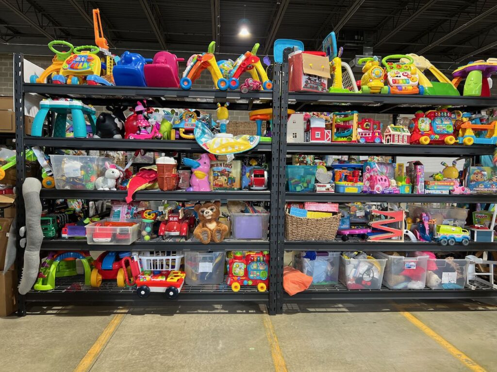 Shelves full of colorful children's toys during a family volunteering session at Share our Spare in Chicago